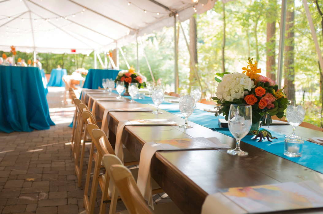 Farm tables under tent for formal event