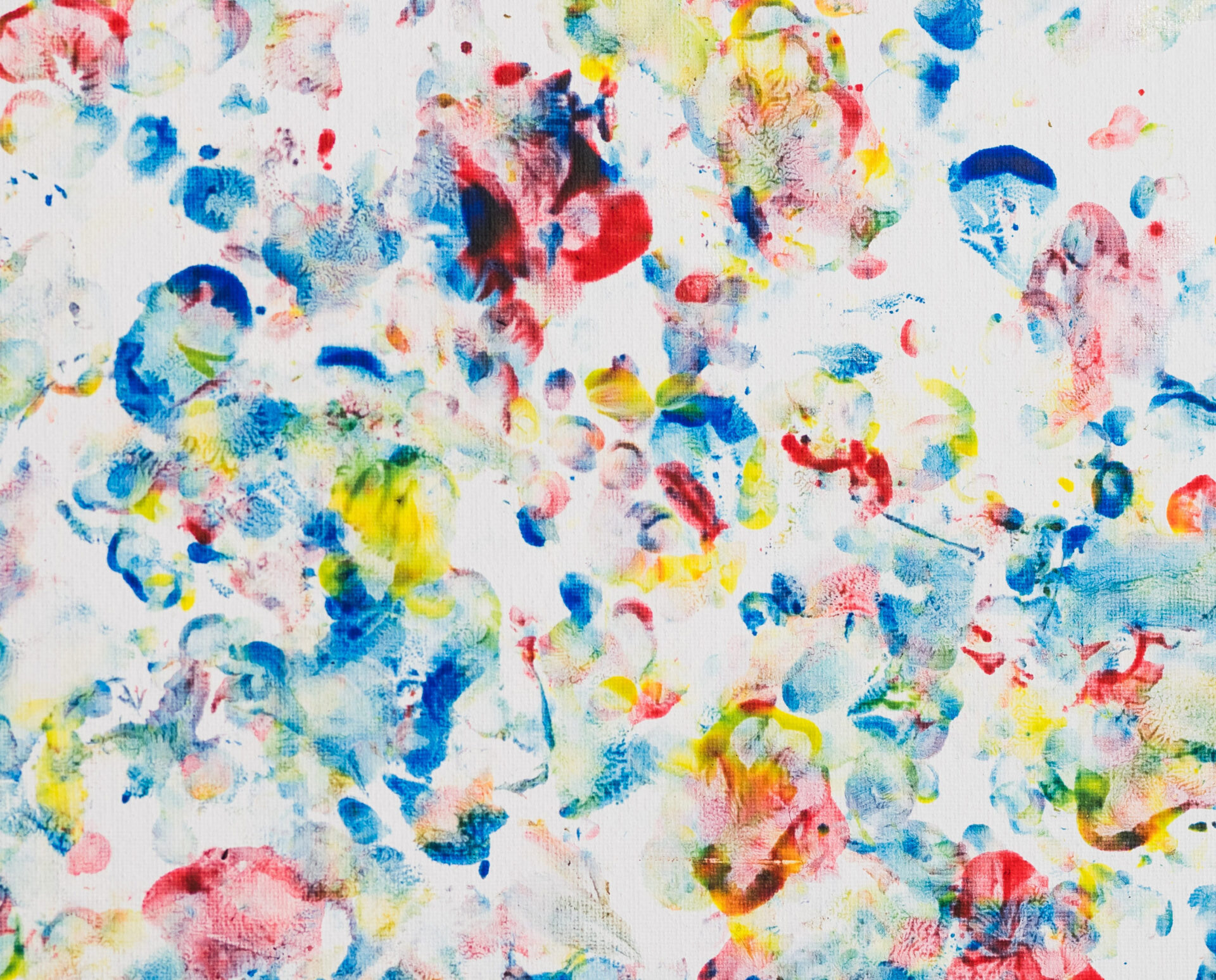 blue, red, and yellow patches of paint on a white background