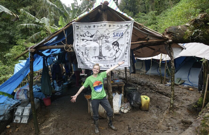 Duke graduate student Caroline DeSisto in front of a covered shelter in the forest of Madagascar.